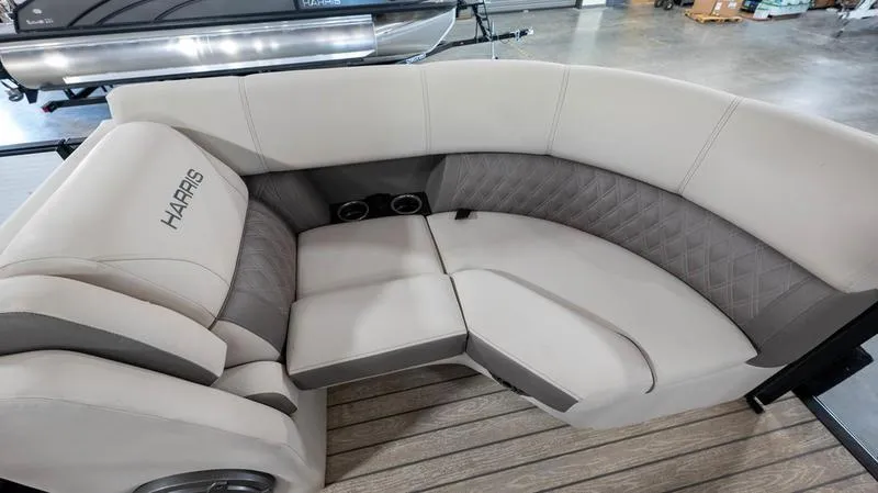 Slide: The Image of 2021 Harris SUNLINER 230 SLDH boat interior seating with beige upholstery and cup holders. - 5