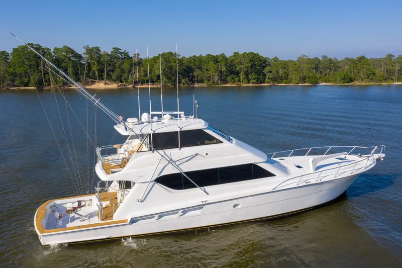 The Image of 2003 Hatteras 70 Convertible yacht on calm water. - 0