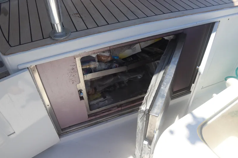 Slide: The Image of Open storage compartment on a 2003 Hatteras 70 Convertible yacht. - 10