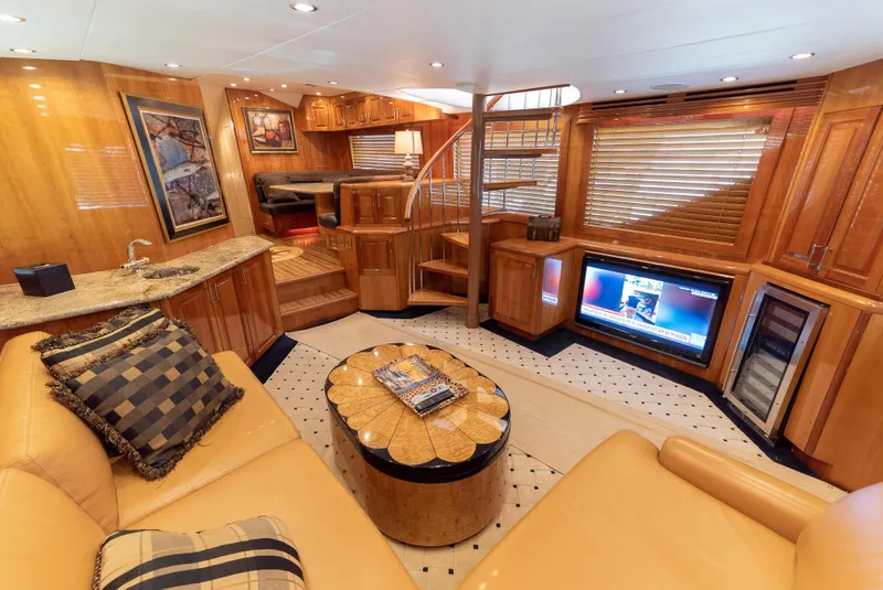 Slide: The Image of Luxurious interior of a 2003 Hatteras 70 Convertible yacht with modern amenities. - 16