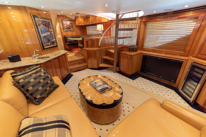 Slide: The Image of Luxurious interior of a 2003 Hatteras 70 Convertible yacht with elegant wood finishes. - 17
