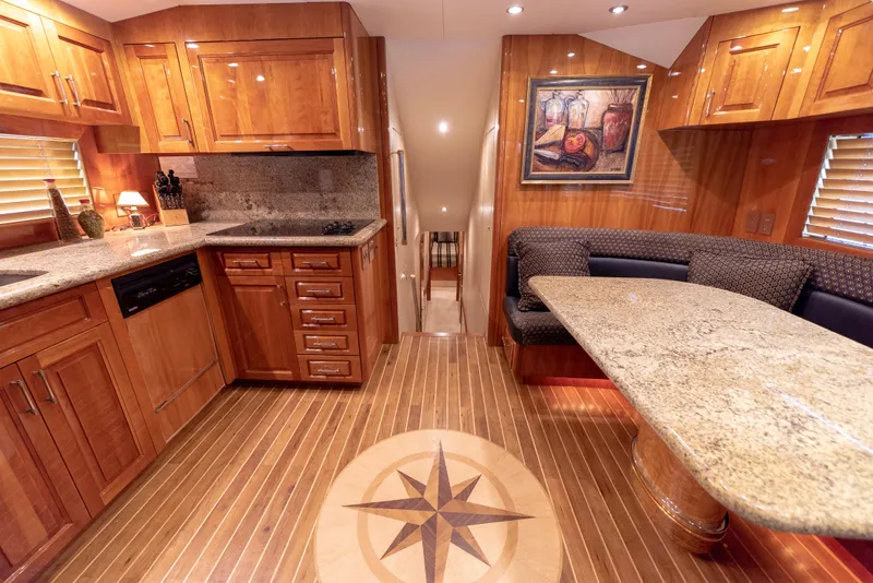 Slide: The Image of Luxurious interior of 2003 Hatteras 70 Convertible yacht with wood cabinetry and granite countertops. - 19