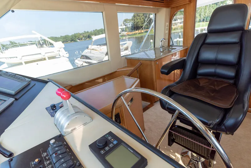 Slide: The Image of Interior helm station of 2003 Hatteras 70 Convertible yacht with leather captain's chair. - 22