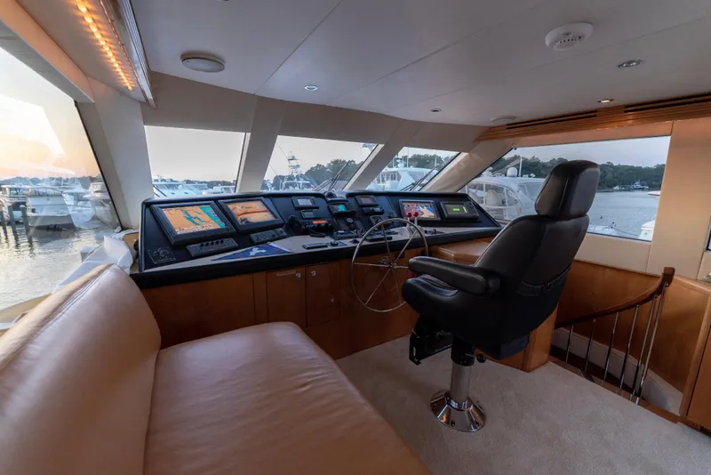 Slide: The Image of Helm station of 2003 Hatteras 70 Convertible yacht with navigation equipment and captain's chair. - 25