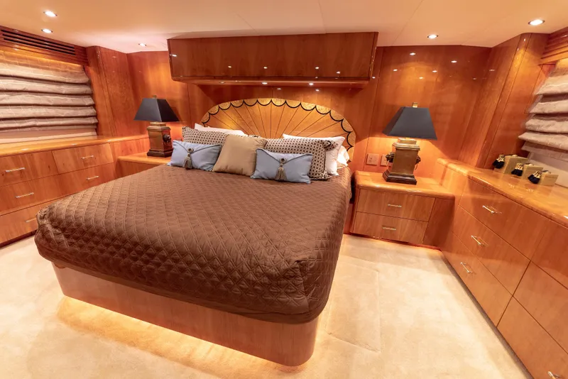 Slide: The Image of Luxurious bedroom interior of 2003 Hatteras 70 Convertible yacht with elegant wood finishes. - 29
