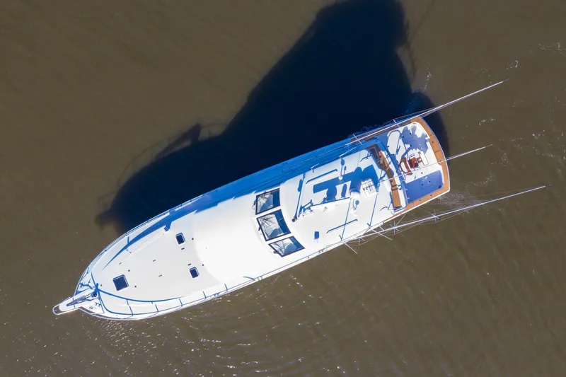 Slide: The Image of Aerial view of 2003 Hatteras 70 Convertible yacht cruising on water. - 3
