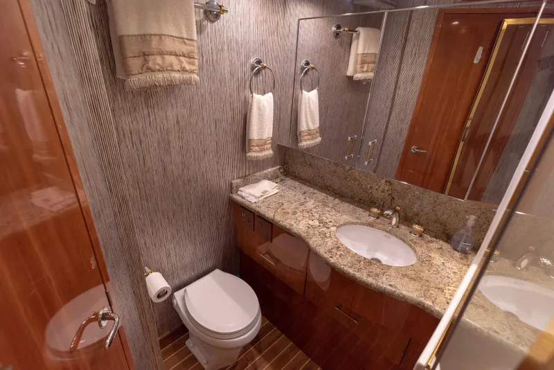 Slide: The Image of Luxurious bathroom in a 2003 Hatteras 70 Convertible yacht with granite countertop. - 31