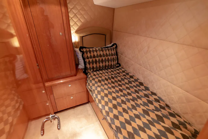 Slide: The Image of Luxurious cabin interior of 2003 Hatteras 70 Convertible yacht with single bed. - 34