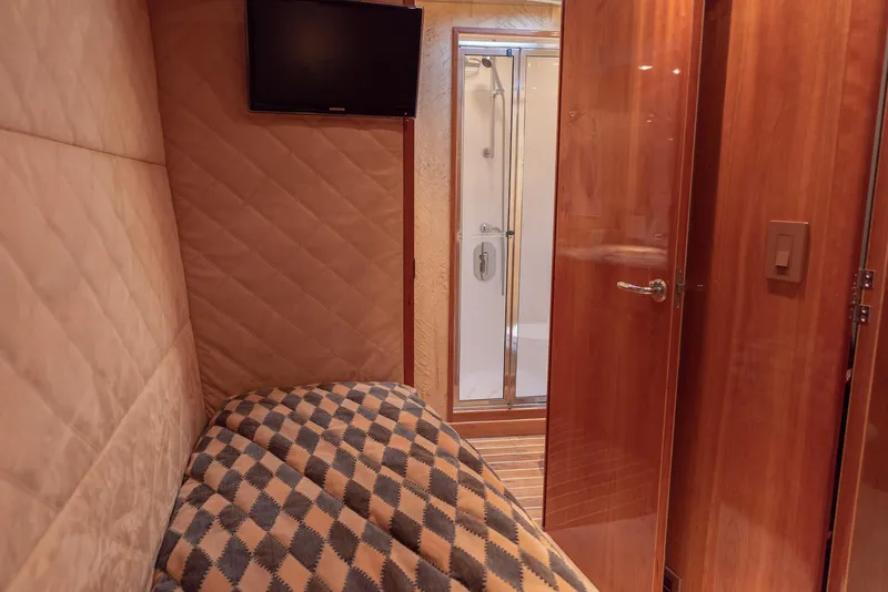 Slide: The Image of Interior cabin of 2003 Hatteras 70 Convertible yacht with bed, TV, and ensuite bathroom. - 35
