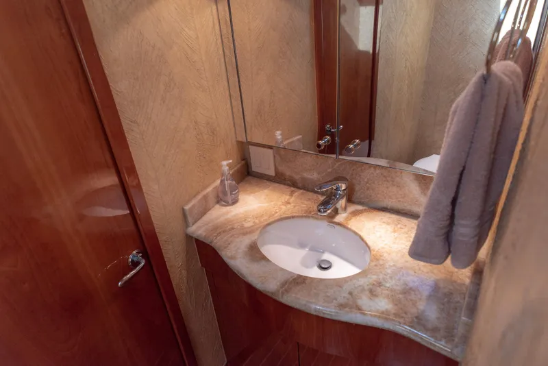 Slide: The Image of Luxurious bathroom in 2003 Hatteras 70 Convertible yacht with marble countertop. - 36