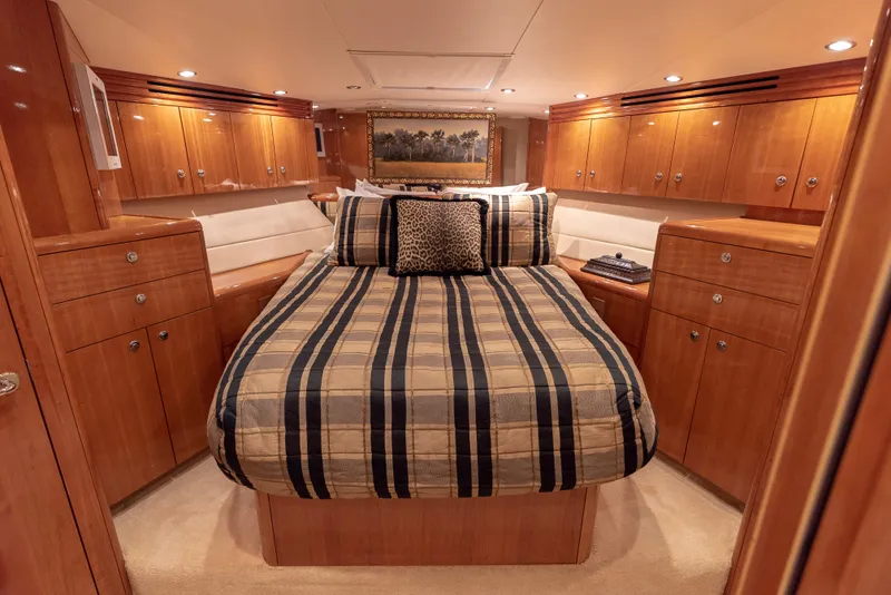 Slide: The Image of Luxurious bedroom interior of a 2003 Hatteras 70 Convertible yacht with wood cabinetry. - 38
