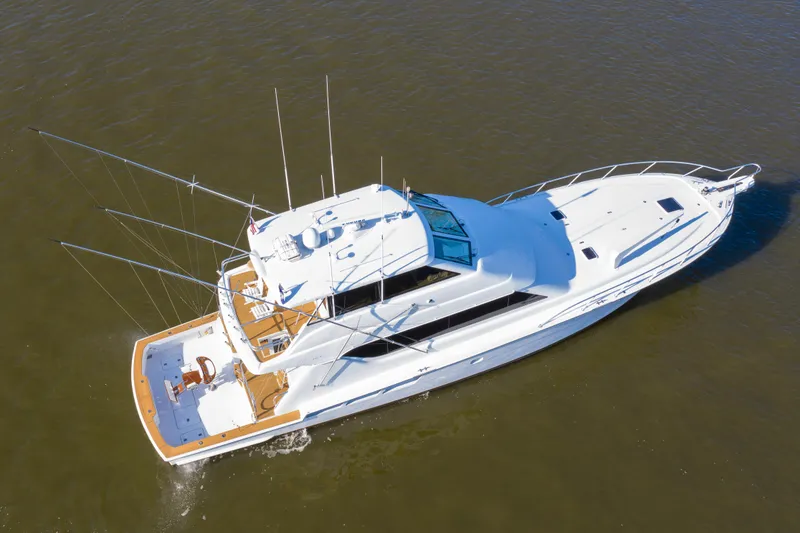 Slide: The Image of Aerial view of a 2003 Hatteras 70 Convertible yacht cruising on the water. - 4
