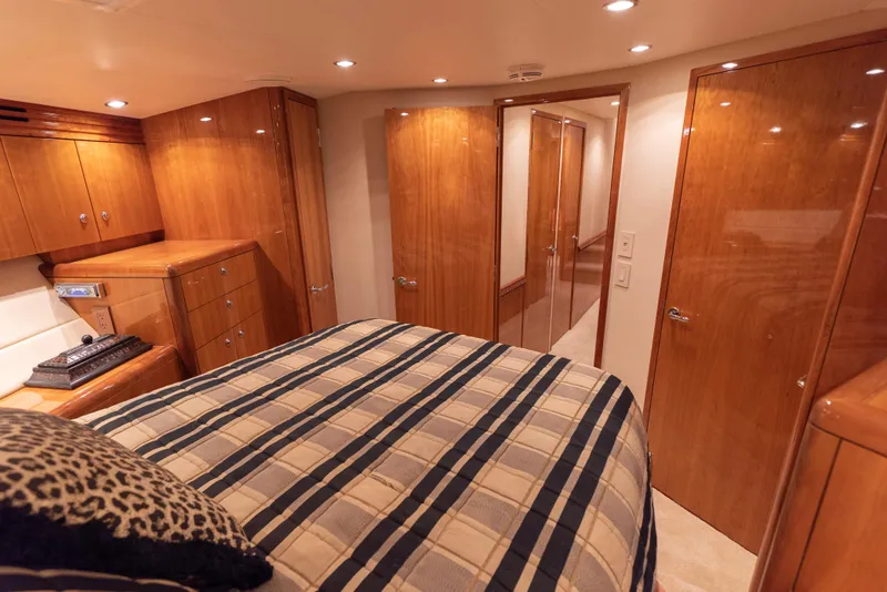 Slide: The Image of Luxurious bedroom interior of 2003 Hatteras 70 Convertible yacht with wood cabinetry. - 40