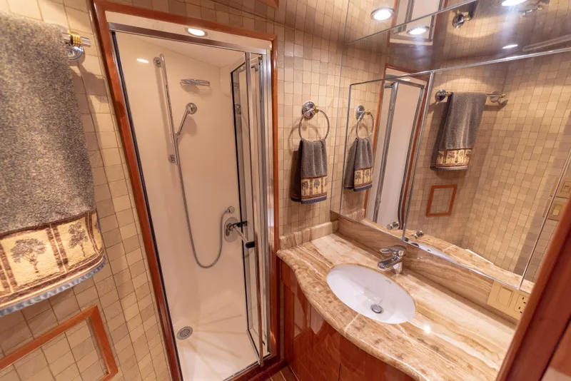 Slide: The Image of Luxurious bathroom in 2003 Hatteras 70 Convertible yacht with shower and marble sink. - 41