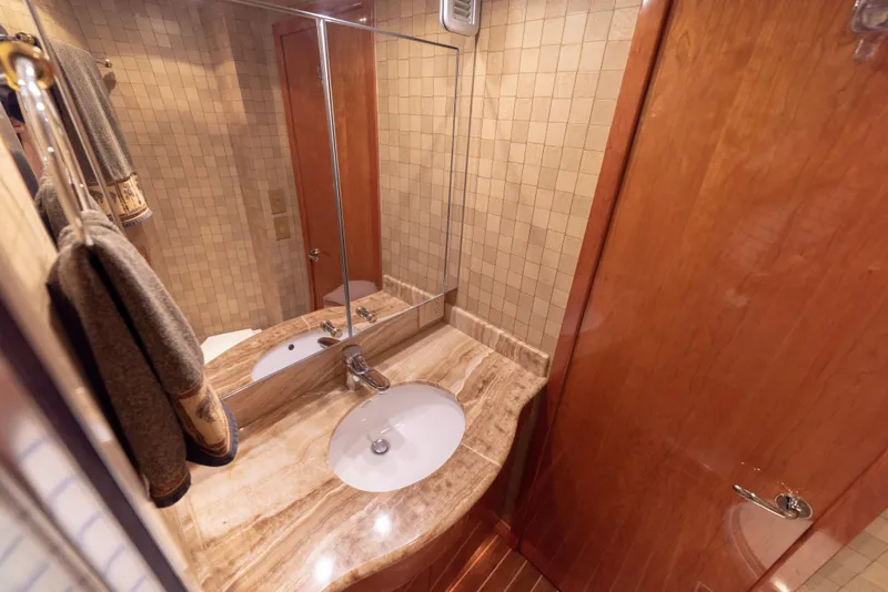 Slide: The Image of Luxurious bathroom in a 2003 Hatteras 70 Convertible yacht with marble countertop. - 42