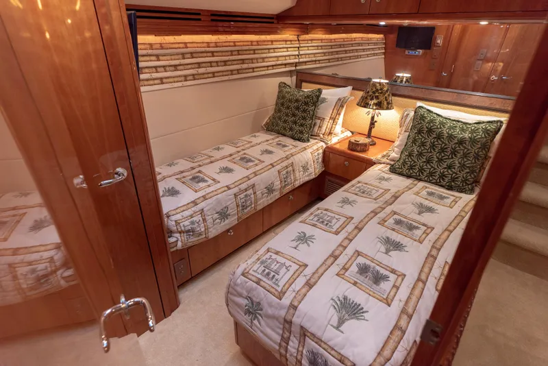 Slide: The Image of Luxurious twin bedroom in a 2003 Hatteras 70 Convertible yacht with elegant decor. - 44