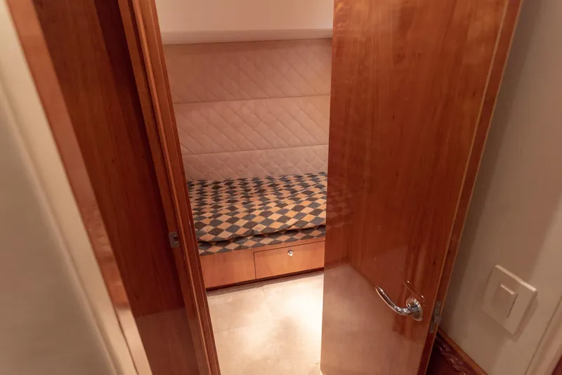 Slide: The Image of Small cabin interior of 2003 Hatteras 70 Convertible yacht with wooden door. - 47