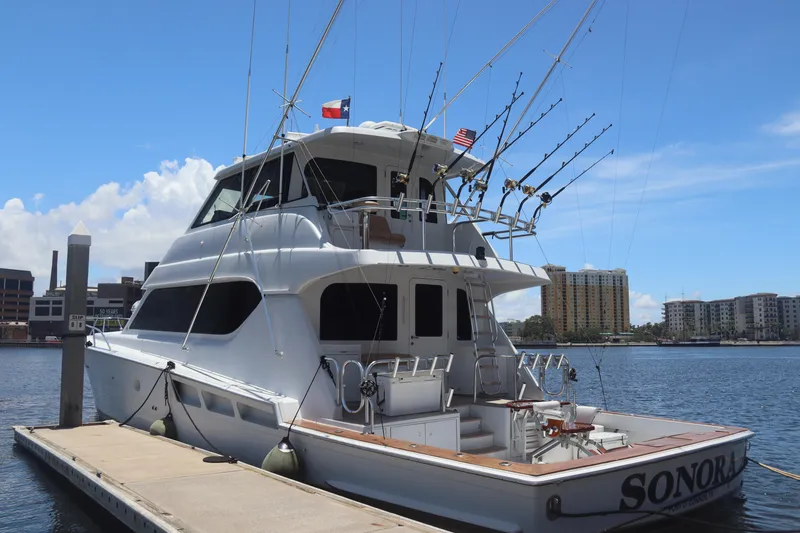 Slide: The Image of 2003 Hatteras 70 Convertible yacht docked at marina with fishing rods. - 7
