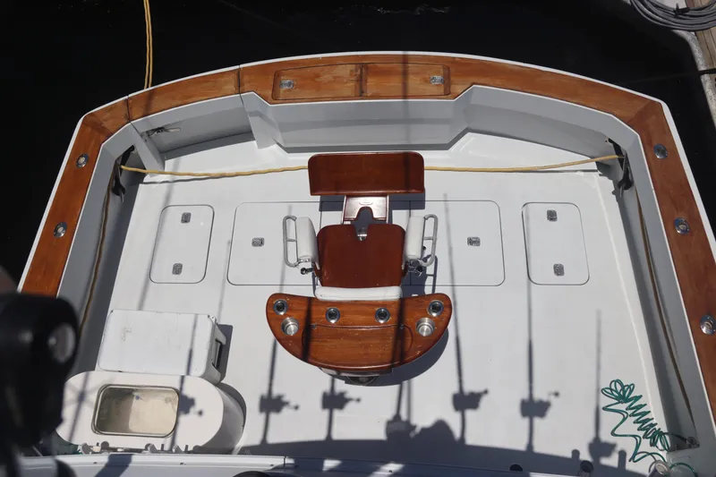 Slide: The Image of 2003 Hatteras 70 Convertible fishing deck with fighting chair and storage compartments. - 8