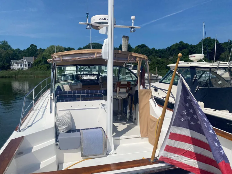 Slide: The Image of Sabre 36 yacht, 2003 model, docked with American flag, sunny day. - 11