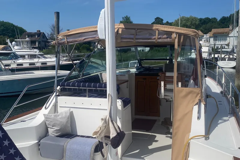 Slide: The Image of 2003 Sabre 36 yacht docked at a marina with a view of the cockpit and seating area. - 13