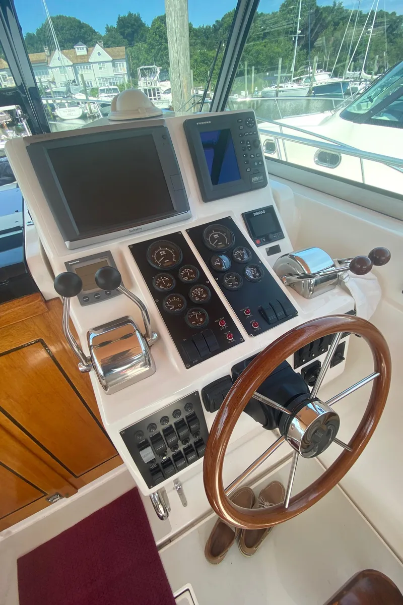 Slide: The Image of Helm station of a 2003 Sabre 36 yacht with navigation equipment and wooden steering wheel. - 14