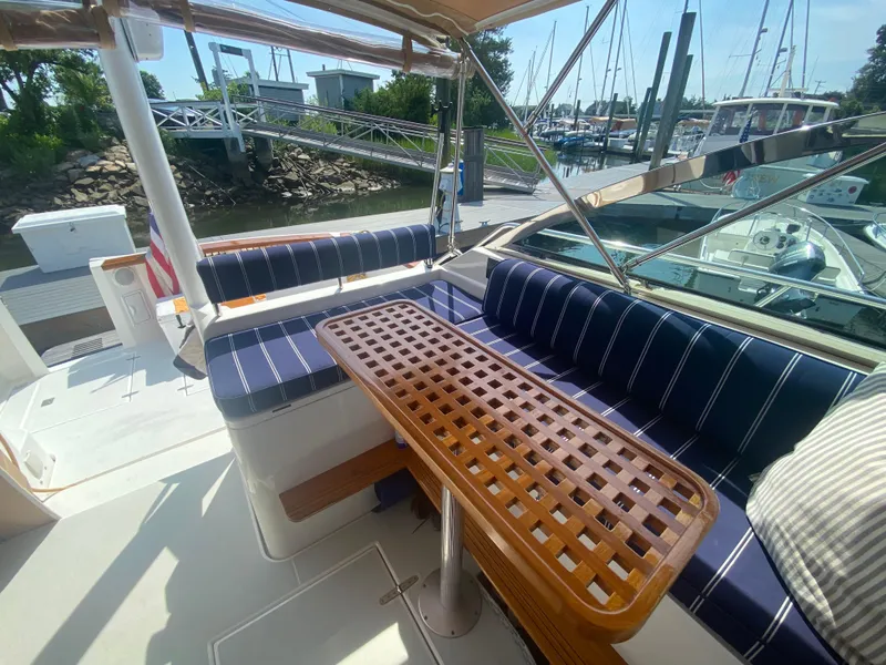 Slide: The Image of 2003 Sabre 36 yacht with cushioned seating and wooden table in the cockpit area. - 5
