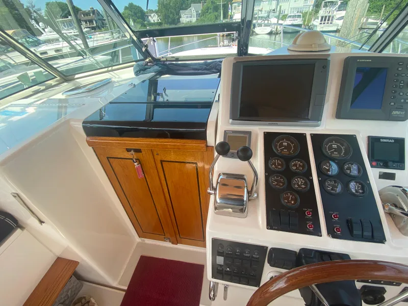 Slide: The Image of 2003 Sabre 36 boat cockpit with navigation instruments and wooden cabinetry. - 6