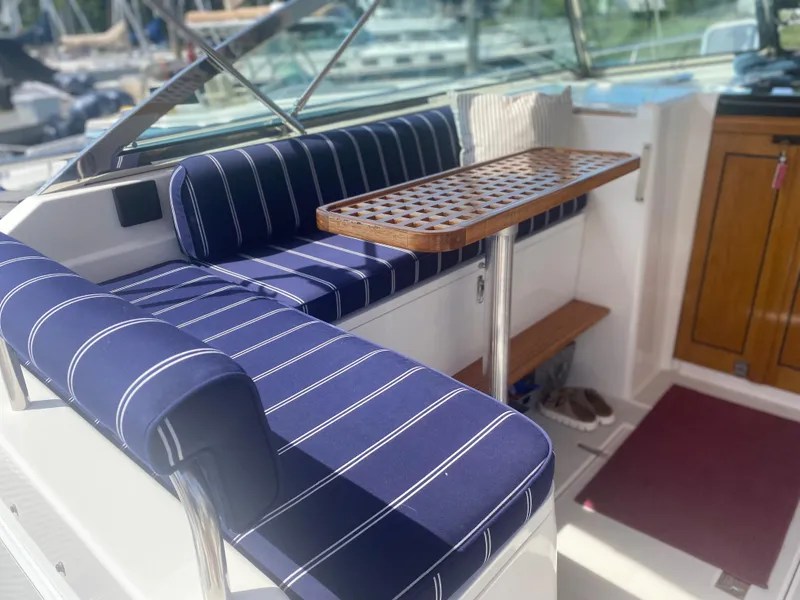 Slide: The Image of Interior seating area of a 2003 Sabre 36 boat with blue striped cushions. - 7
