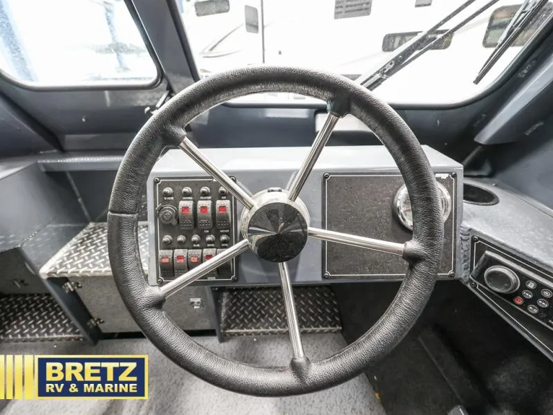 Slide: The Image of 2024 Sea Runner 190 ET HT boat steering wheel and control panel at Bretz RV & Marine. - 13