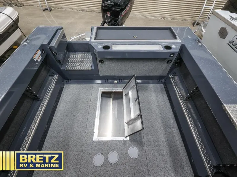 Slide: The Image of 2024 Sea Runner 190 ET HT boat interior with storage compartments and motor, Bretz RV & Marine. - 19