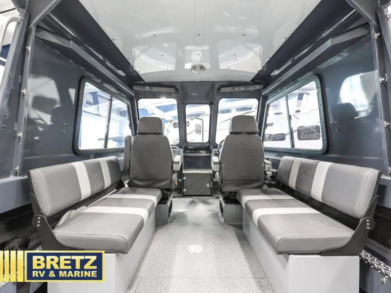 Slide: The Image of Interior of 2024 Sea Runner 190 ET HT boat with seating, windows, and Bretz RV & Marine logo. - 9