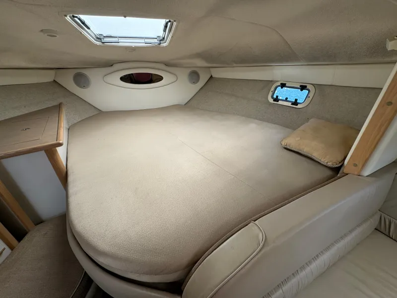 Slide: The Image of 1997 Maxum 3200 SCR cabin interior with bed, skylight, and side window. - 11