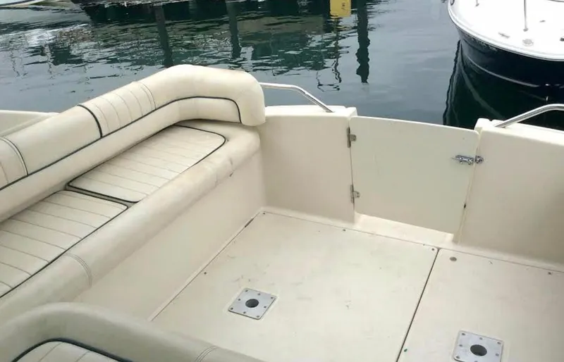 Slide: The Image of 1997 Maxum 3200 SCR boat interior with white seating and open deck area. - 16