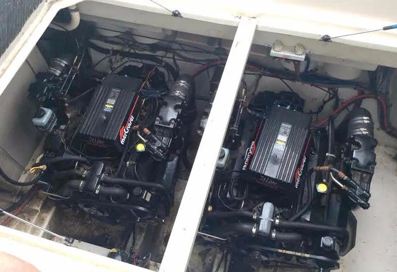 Slide: The Image of Twin engines in a 1997 Maxum 3200 SCR boat, showcasing detailed mechanical components. - 19