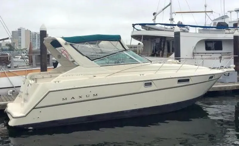 Slide: The Image of 1997 Maxum 3200 SCR boat docked at marina, side view. - 21