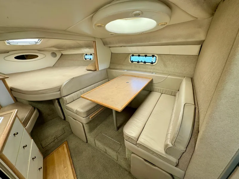 Slide: The Image of 1997 Maxum 3200 SCR cabin interior with dining area and sleeping quarters. - 7