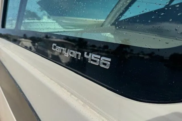 Slide: The Image of 2024 Grady-White Canyon 456 boat nameplate with raindrops on window. - 15