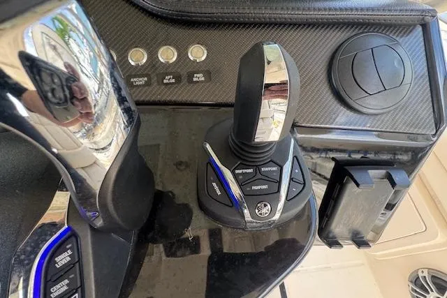 Slide: The Image of 2024 Grady-White Canyon 456 boat control panel with joystick and buttons. - 21