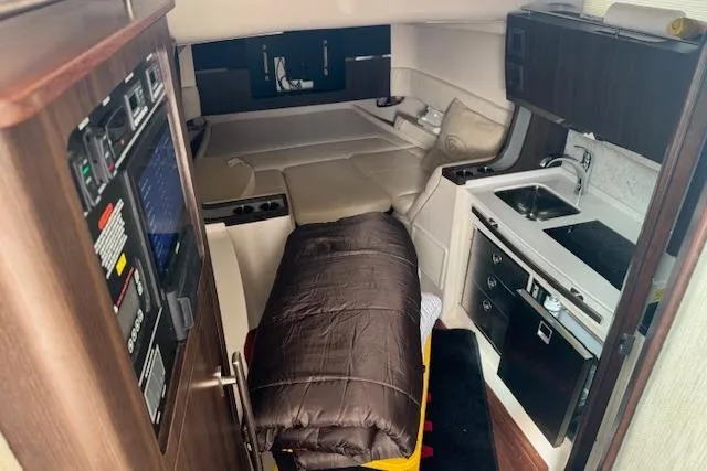 Slide: The Image of 2024 Grady-White Canyon 456 cabin interior with kitchenette and sleeping area. - 23