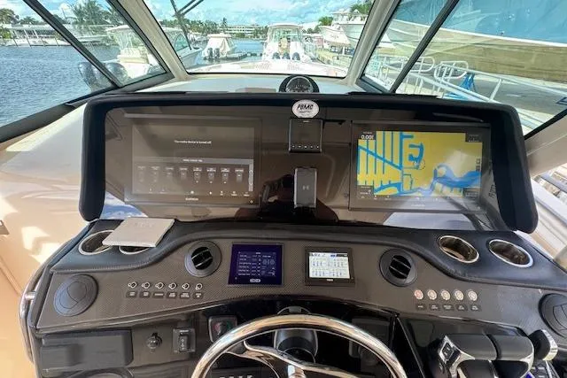 Slide: The Image of 2024 Grady-White Canyon 456 helm with advanced navigation and control systems. - 24