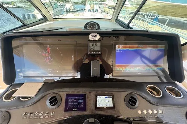 Slide: The Image of 2024 Grady-White Canyon 456 boat dashboard with advanced navigation and control systems. - 25