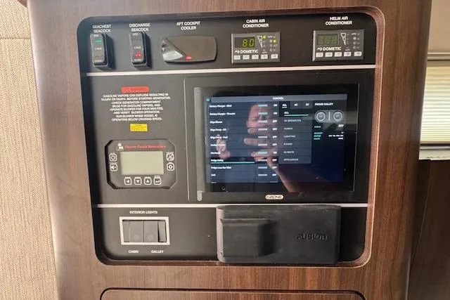Slide: The Image of Control panel of 2024 Grady-White Canyon 456 boat with digital display and switches. - 28