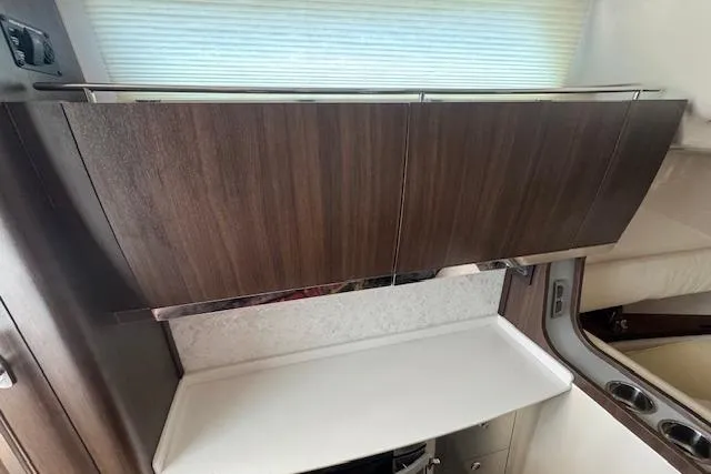 Slide: The Image of 2024 Grady-White Canyon 456 interior with sleek wooden cabinetry and modern design. - 36