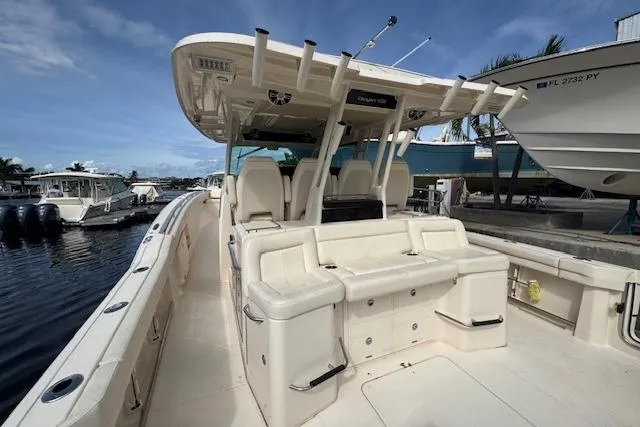 Slide: The Image of 2024 Grady-White Canyon 456 boat with spacious seating and modern design docked by the water. - 7