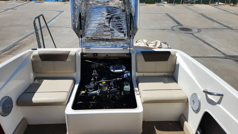 Slide: The Image of 2015 Bayliner 175 Bowrider with open engine compartment and seating area. - 4