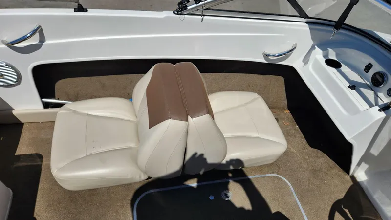 Slide: The Image of 2015 Bayliner 175 Bowrider interior with beige seats and brown accents. - 5