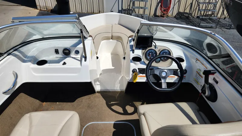 Slide: The Image of 2015 Bayliner 175 Bowrider interior, featuring steering wheel, dashboard, and seating. - 7