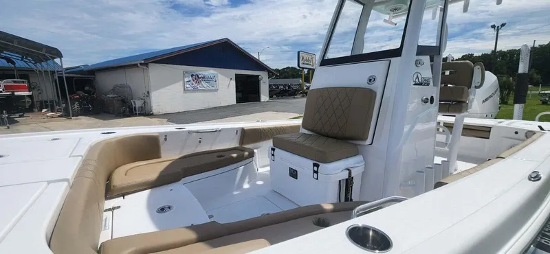 Slide: The Image of 2025 Blazer Bay 2440 boat with tan seating and white deck. - 11