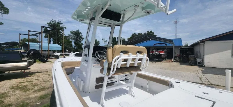 Slide: The Image of 2025 Blazer Bay 2440 boat with center console and seating, docked at a marina. - 3